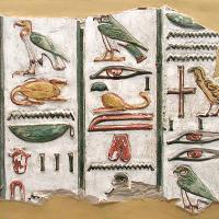 Hieroglyphs in color on a white background