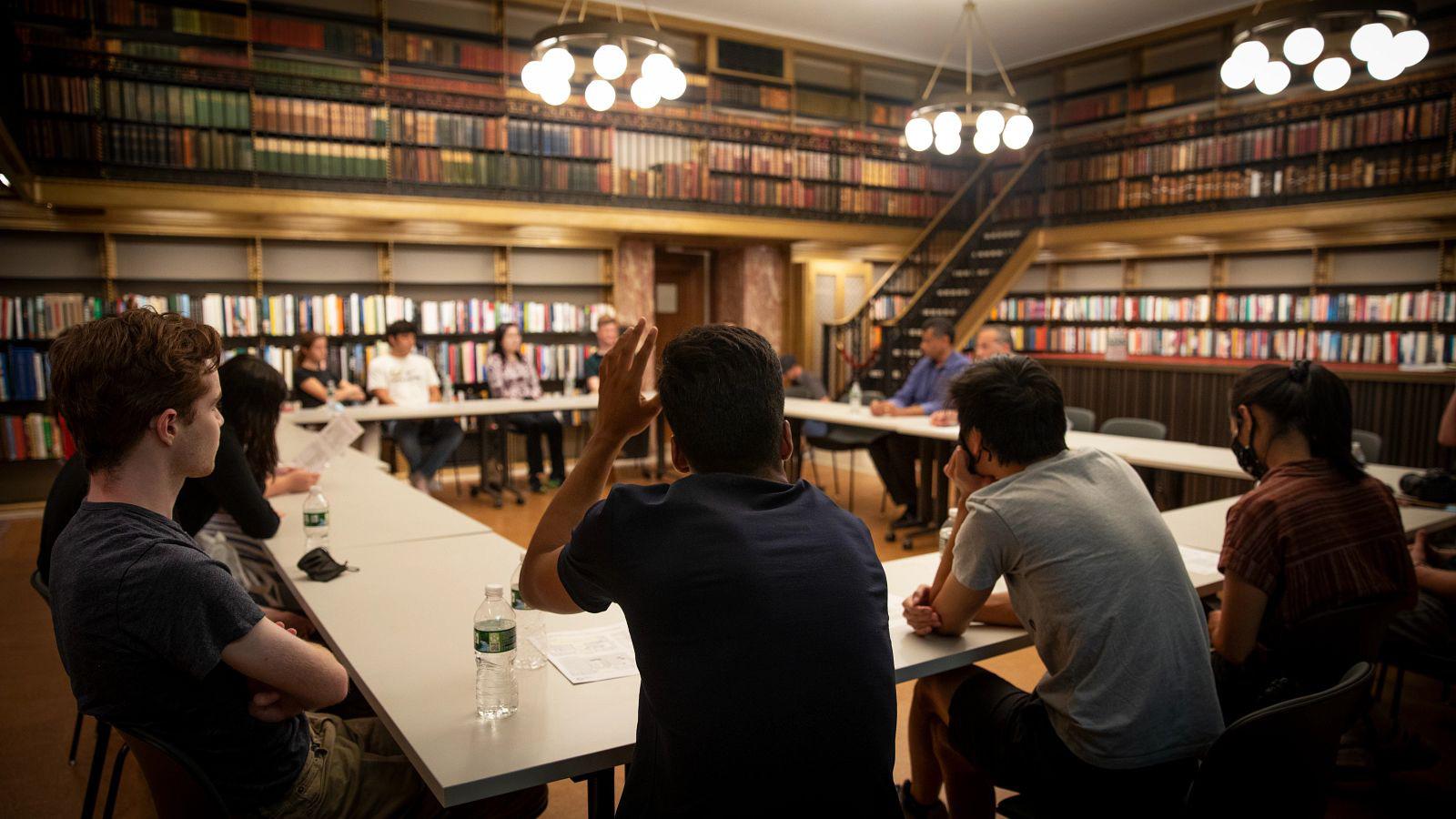 students seated around a table in class