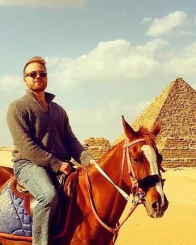 Kyle on a horse in front of the pyramids in Egypt