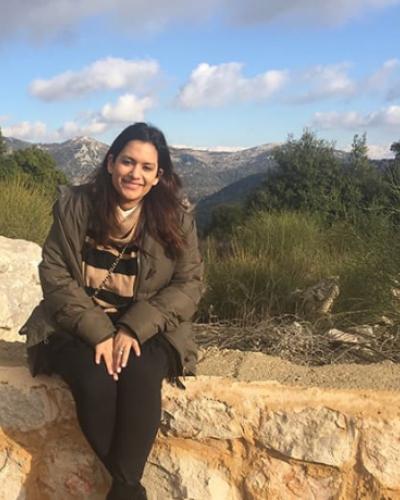 Salma Shitia seated on a wall